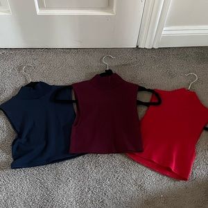 Three turtleneck cropped tank tops.